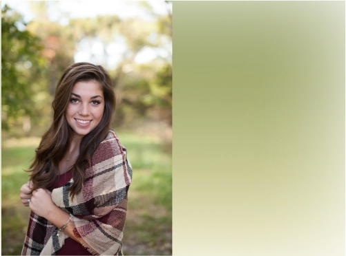 A smiling brown haired woman with a plaid shirt